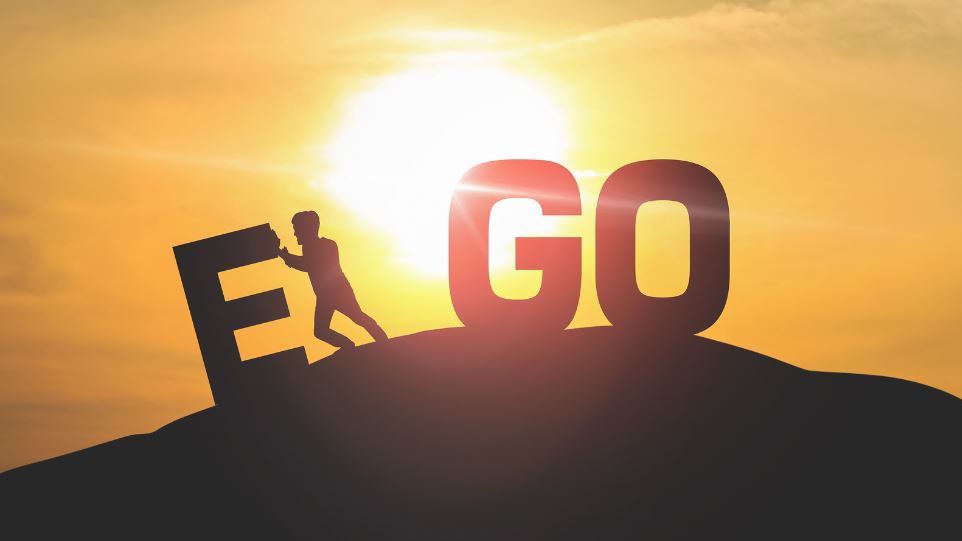 Egoless Hospitality : Three letters: EGO on a mountain. Man pushes the E away.